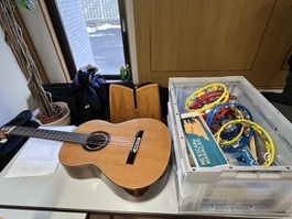 テーブル上に置かれたギター、タンバリン、マラカスなどの楽器類